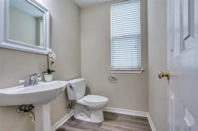 a bathroom with a sink toilet and a mirror