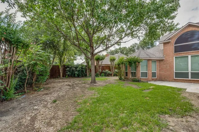 a backyard of a house with table and chairs
