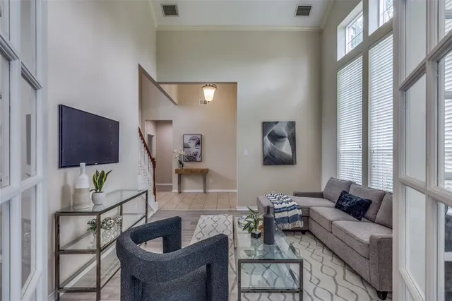 a living room with furniture and wooden floor
