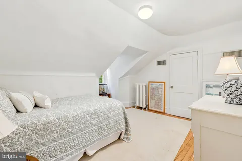 a bedroom with a bed and a lamp