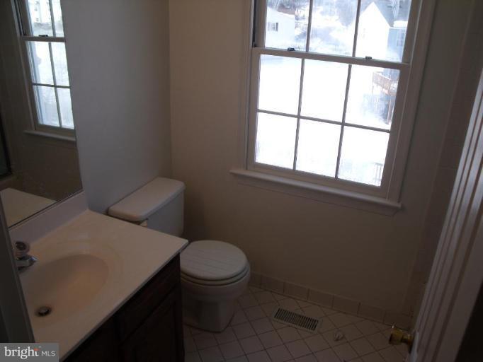 2963 Gracefield Road Silver Spring, MD 20904 - Photo 16 of 30 a bathroom with a sink toilet and window