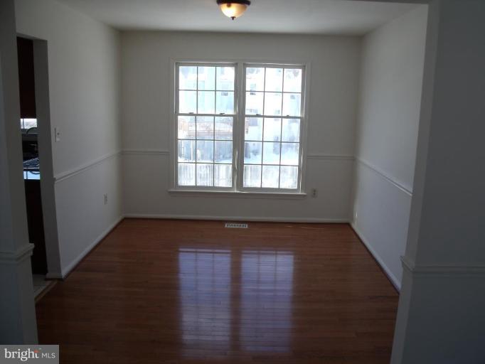 2963 Gracefield Road Silver Spring, MD 20904 - Photo 24 of 30 an empty room with wooden floor and windows