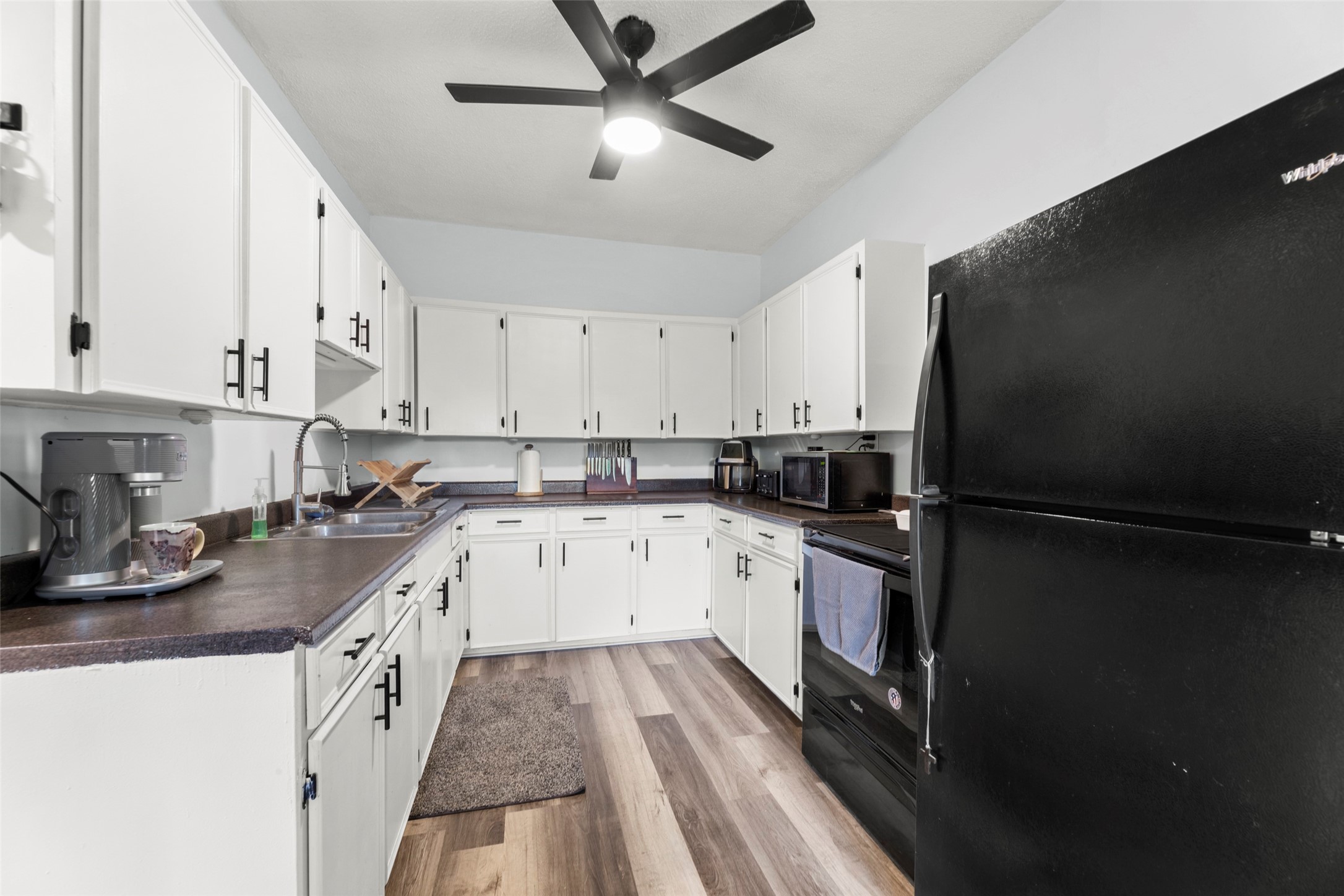 703 Pecan Valley Road Wharton, TX 77488 - Photo 12 of 47 The kitchen offers wrap around upper & lower cabinetry and tons of counterspace.