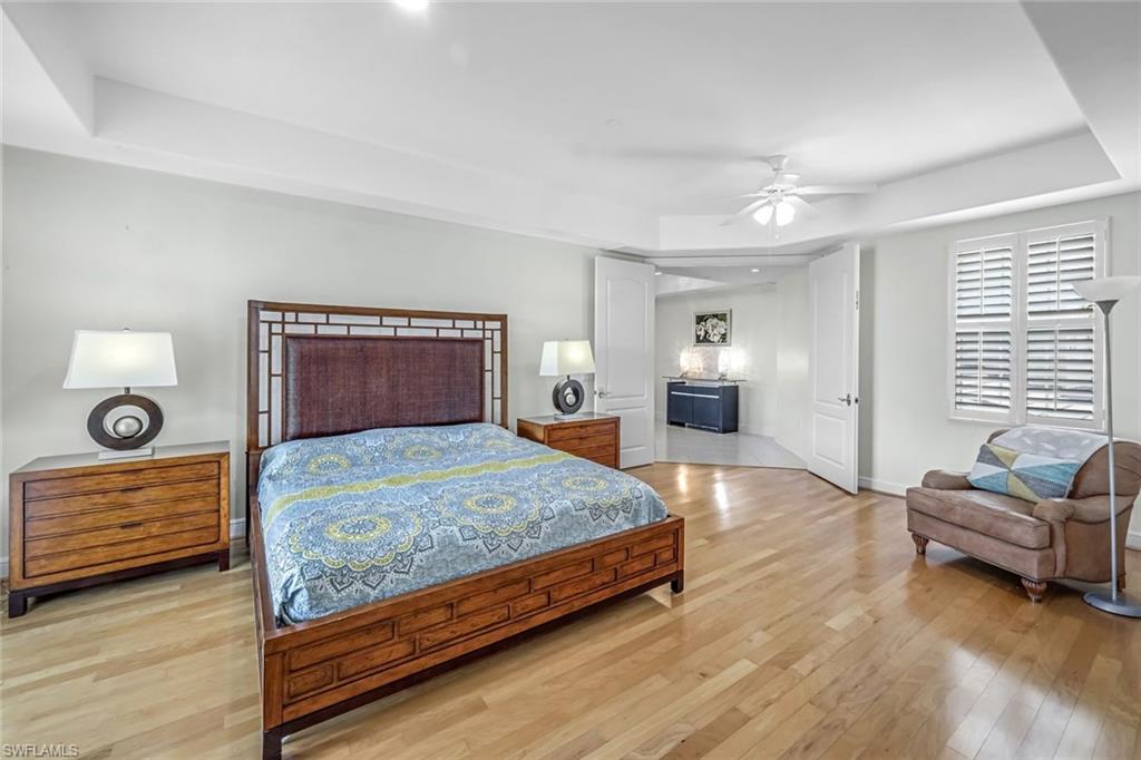 510 Avellino Isles Circle, Unit 2202 Naples, FL 34119 - Photo 12 of 35 a bedroom with a bed and window