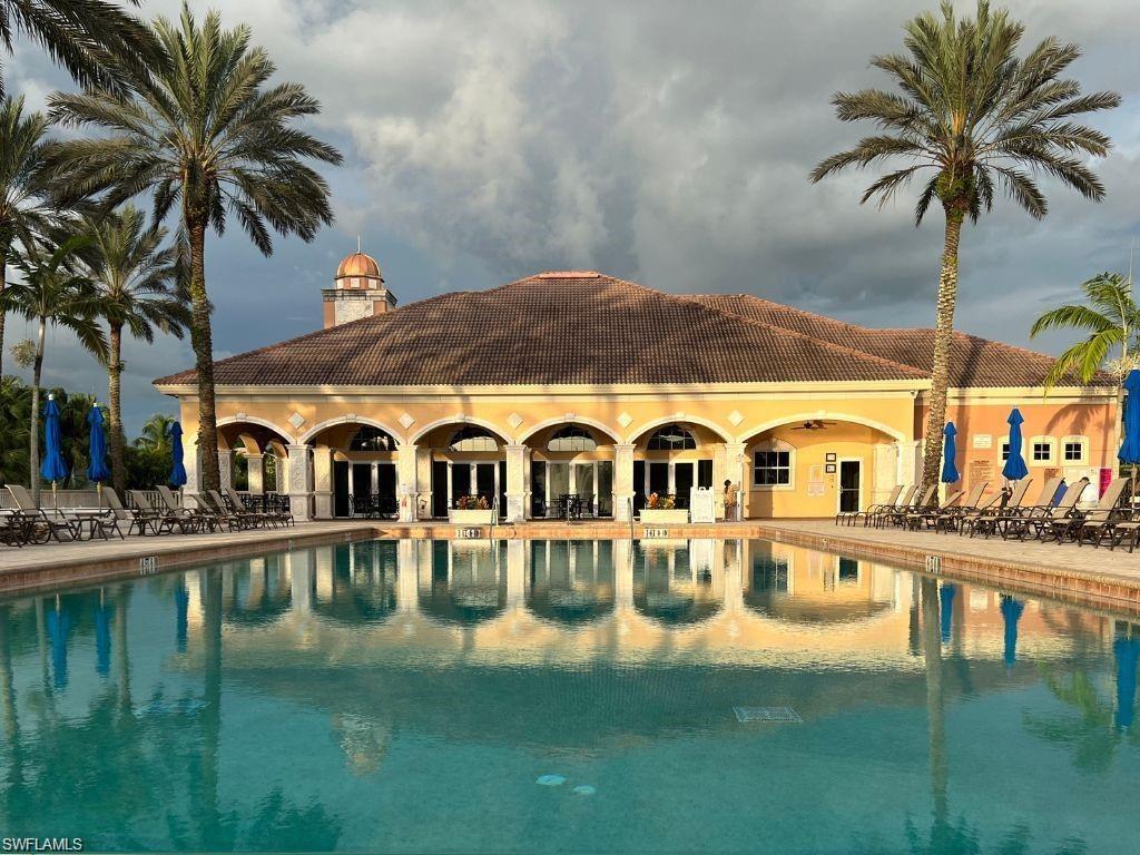 510 Avellino Isles Circle, Unit 2202 Naples, FL 34119 - Photo 28 of 35 a front view of a house with swimming pool having outdoor seating