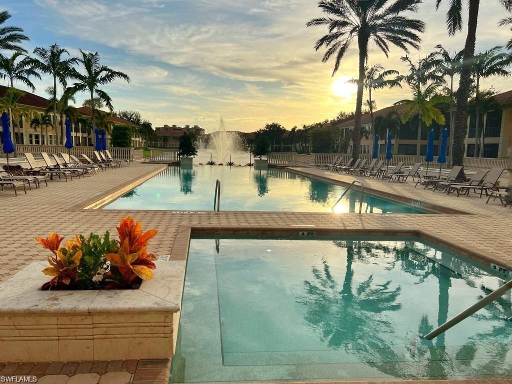 510 Avellino Isles Circle, Unit 2202 Naples, FL 34119 - Photo 29 of 35 a view of swimming pool with a table and chairs