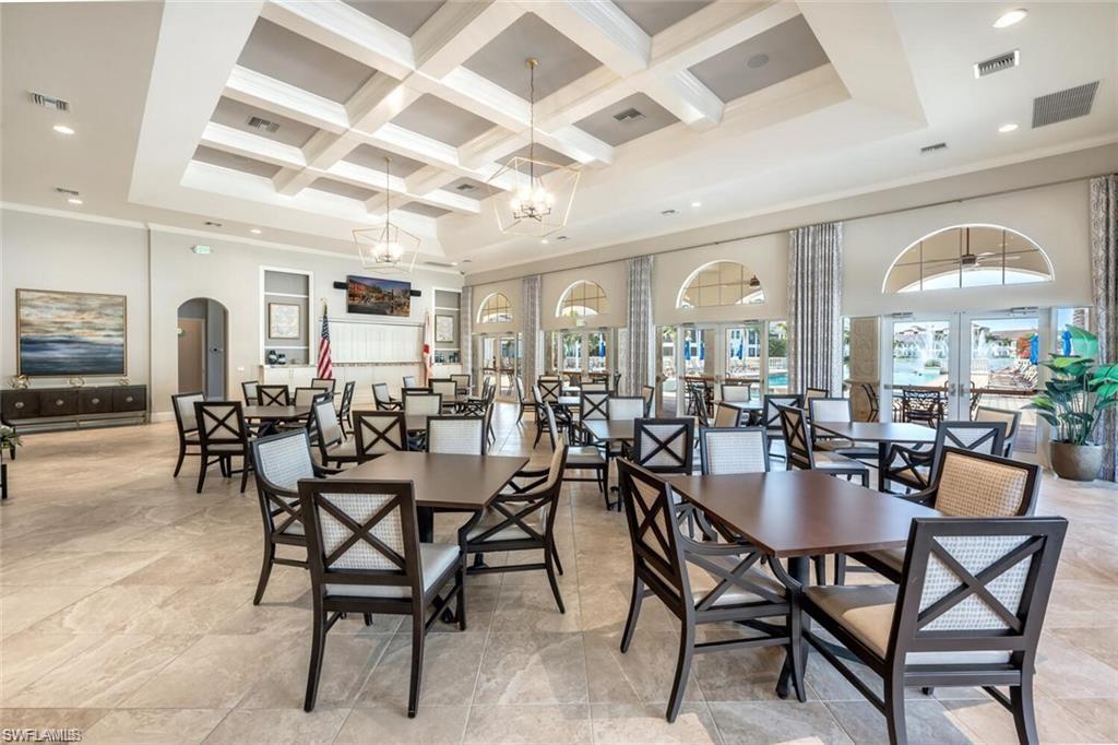 510 Avellino Isles Circle, Unit 2202 Naples, FL 34119 - Photo 31 of 35 a view of a dining room with furniture and chandelier
