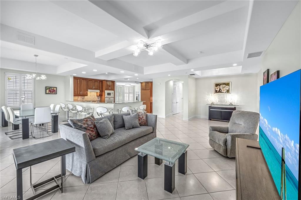 510 Avellino Isles Circle, Unit 2202 Naples, FL 34119 - Photo 6 of 35 a living room with furniture and a large window