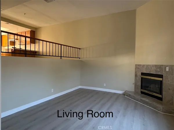 a view of a room with wooden floor and fireplace