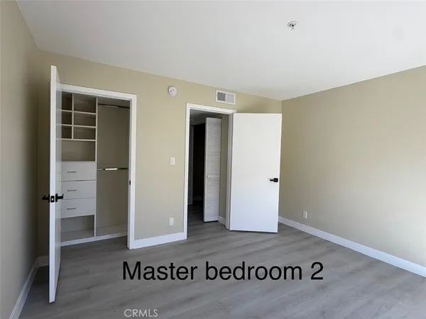 a bathroom with a granite countertop sink a mirror and a shower