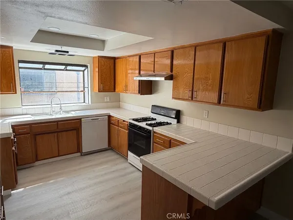 a kitchen with a stove a sink and a microwave