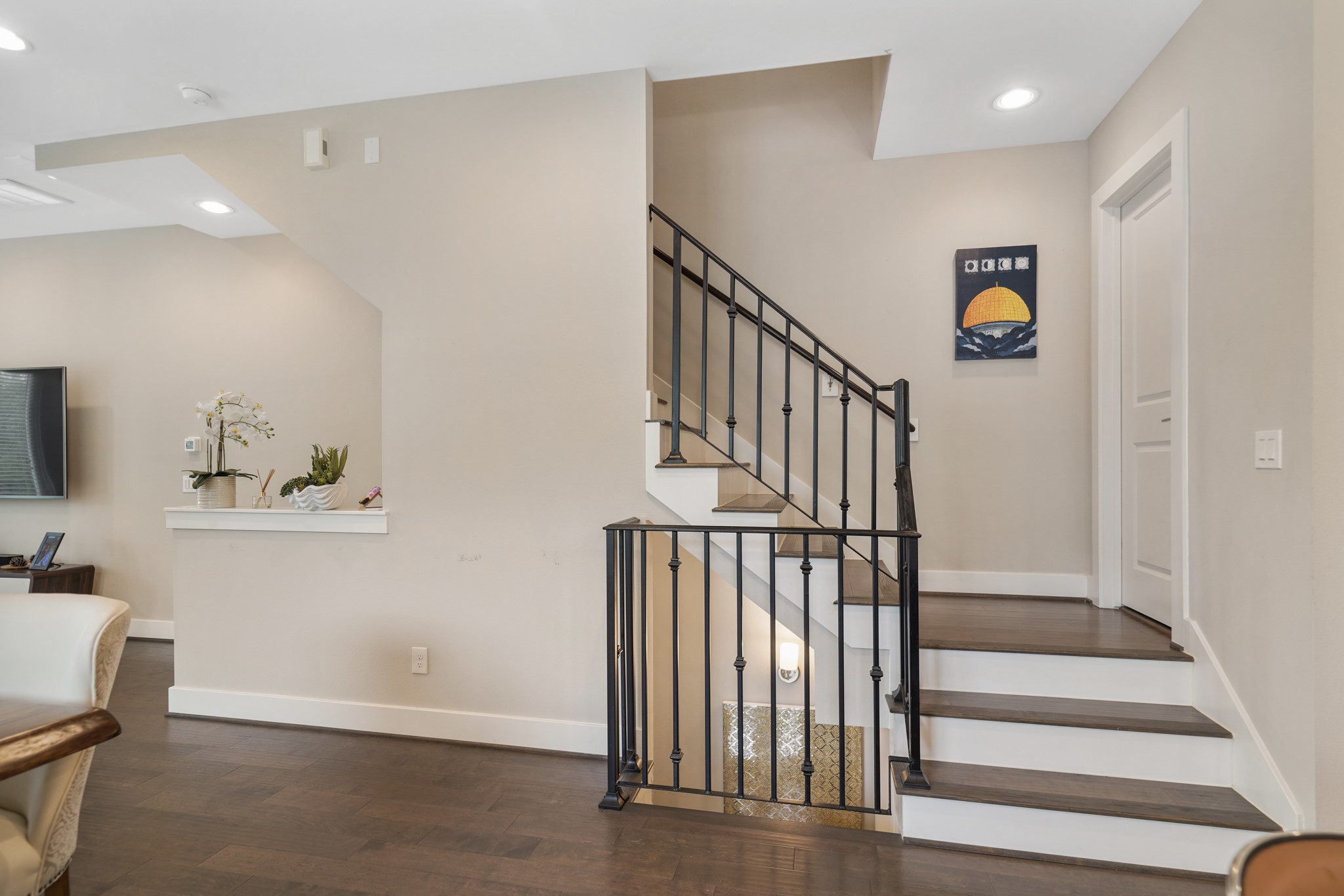 1824 Bonner Street Houston, TX 77007 - Photo 21 of 39 A wrought iron staircase leads to the third level of the home with a half bath accessible through the door on the right.