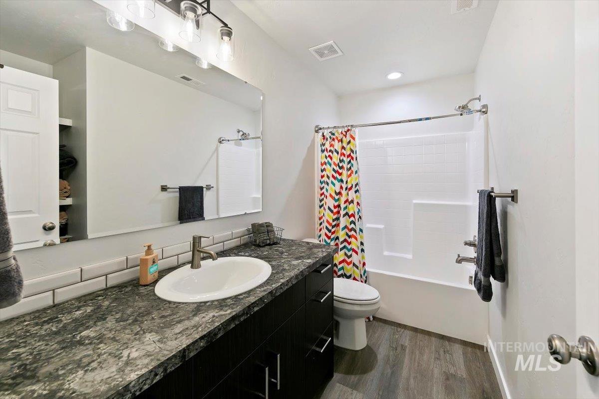 8575 South Foraker Way Kuna, ID 83634 - Photo 31 of 43 Upstairs bathroom with tub shower and lots of counter space and shelving for storage
