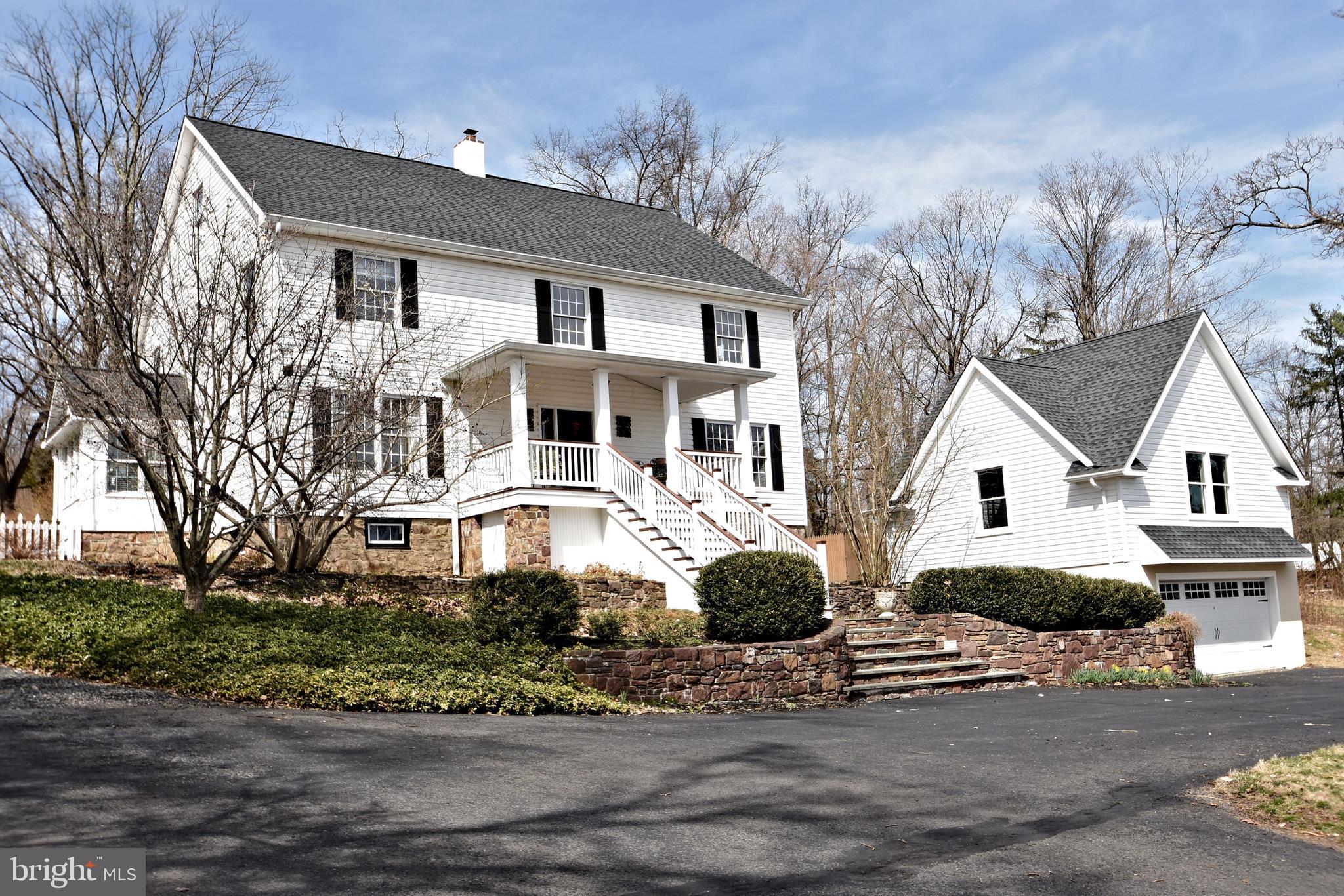312 Ferry Road Doylestown, PA 18901 - Photo 1 of 66 a front view of a house with a yard and garage
