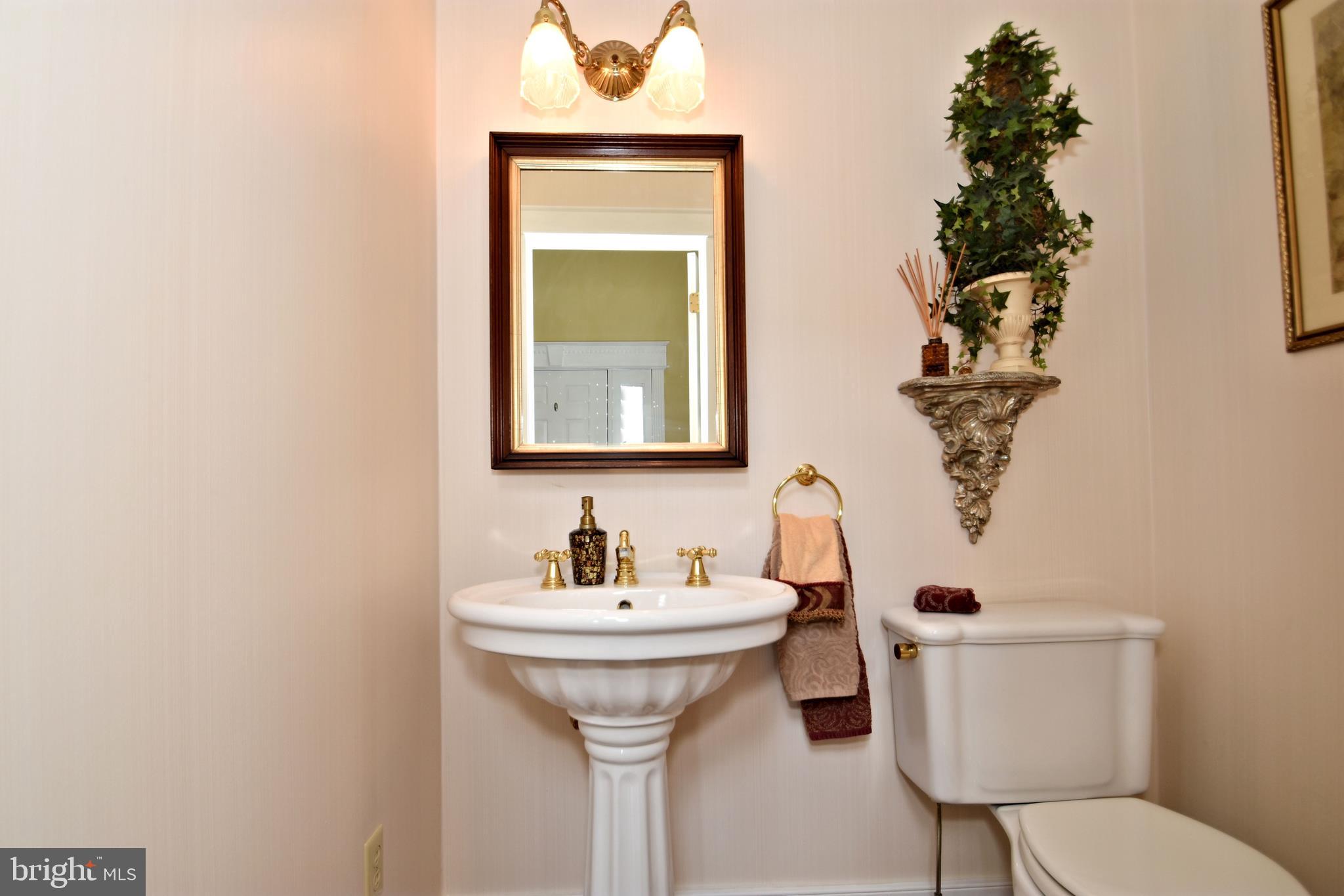 312 Ferry Road Doylestown, PA 18901 - Photo 19 of 66 a bathroom with a toilet sink and mirror
