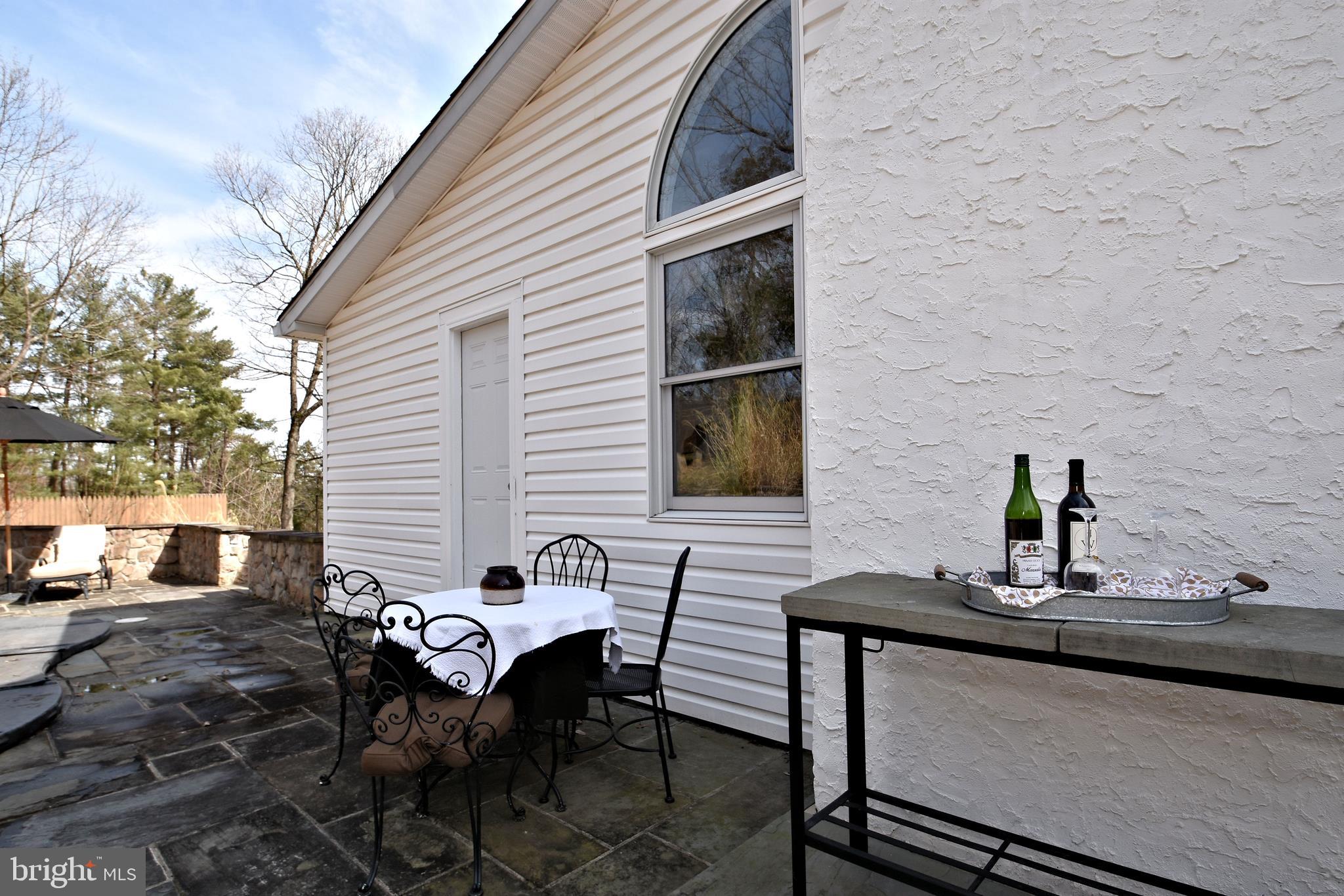 312 Ferry Road Doylestown, PA 18901 - Photo 56 of 66 a view of a patio with table and chairs with wooden floor and fence