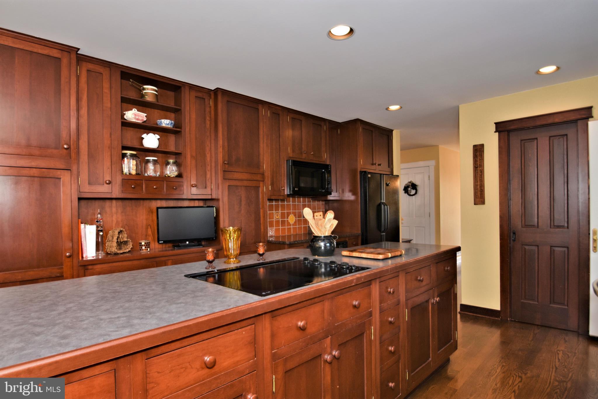 312 Ferry Road Doylestown, PA 18901 - Photo 7 of 66 a kitchen with stainless steel appliances a sink dishwasher stove and wooden cabinets