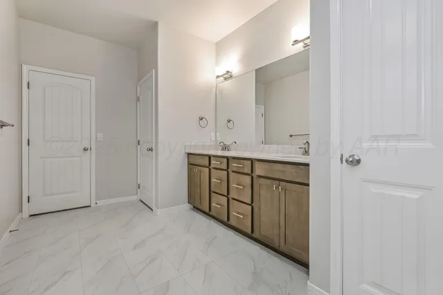 a bathroom with a granite countertop sink two mirror and a