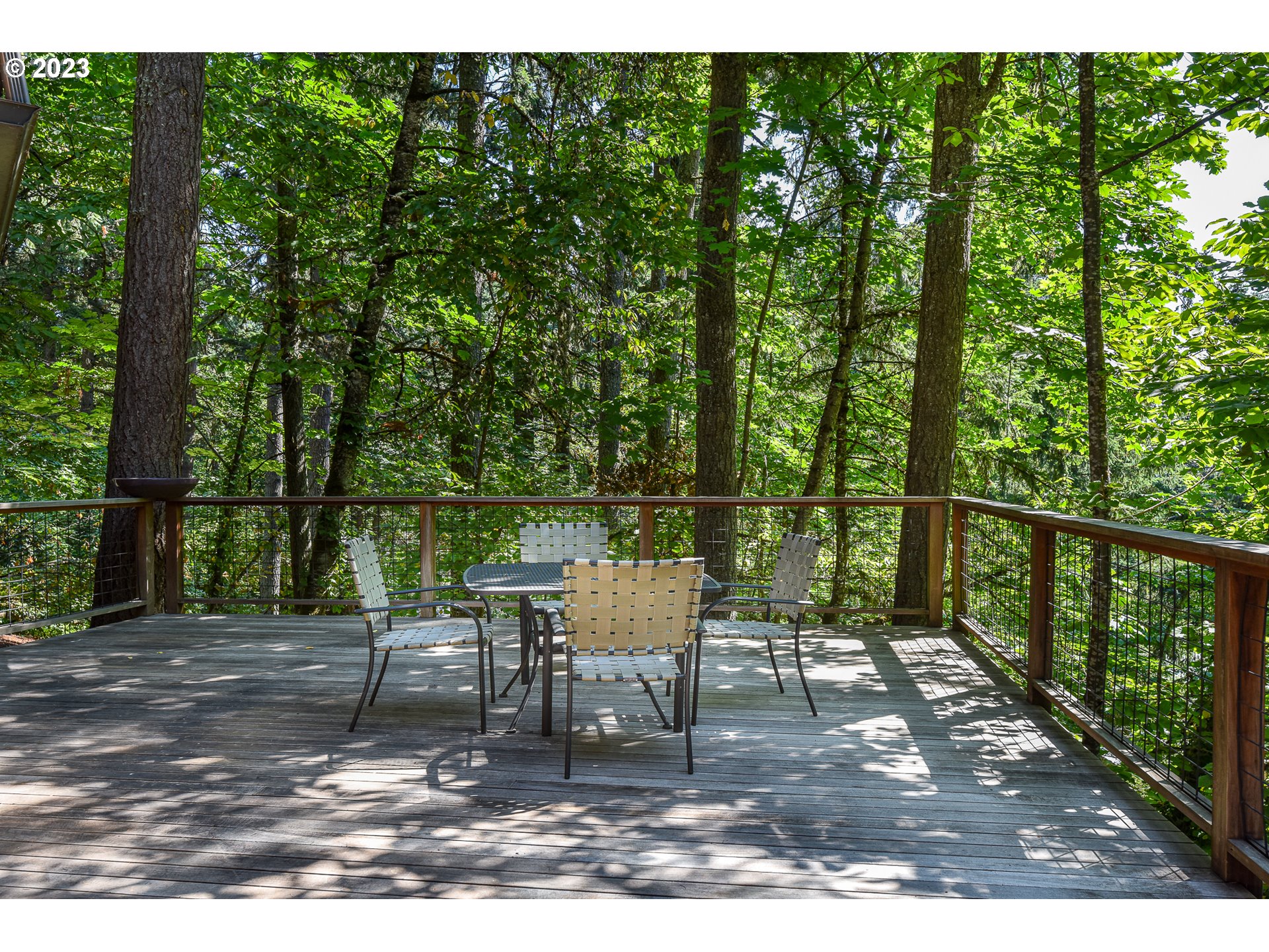 1878 Fircrest Drive Eugene, OR 97403 - Photo 13 of 38 a view of a chair and table on the wooden deck