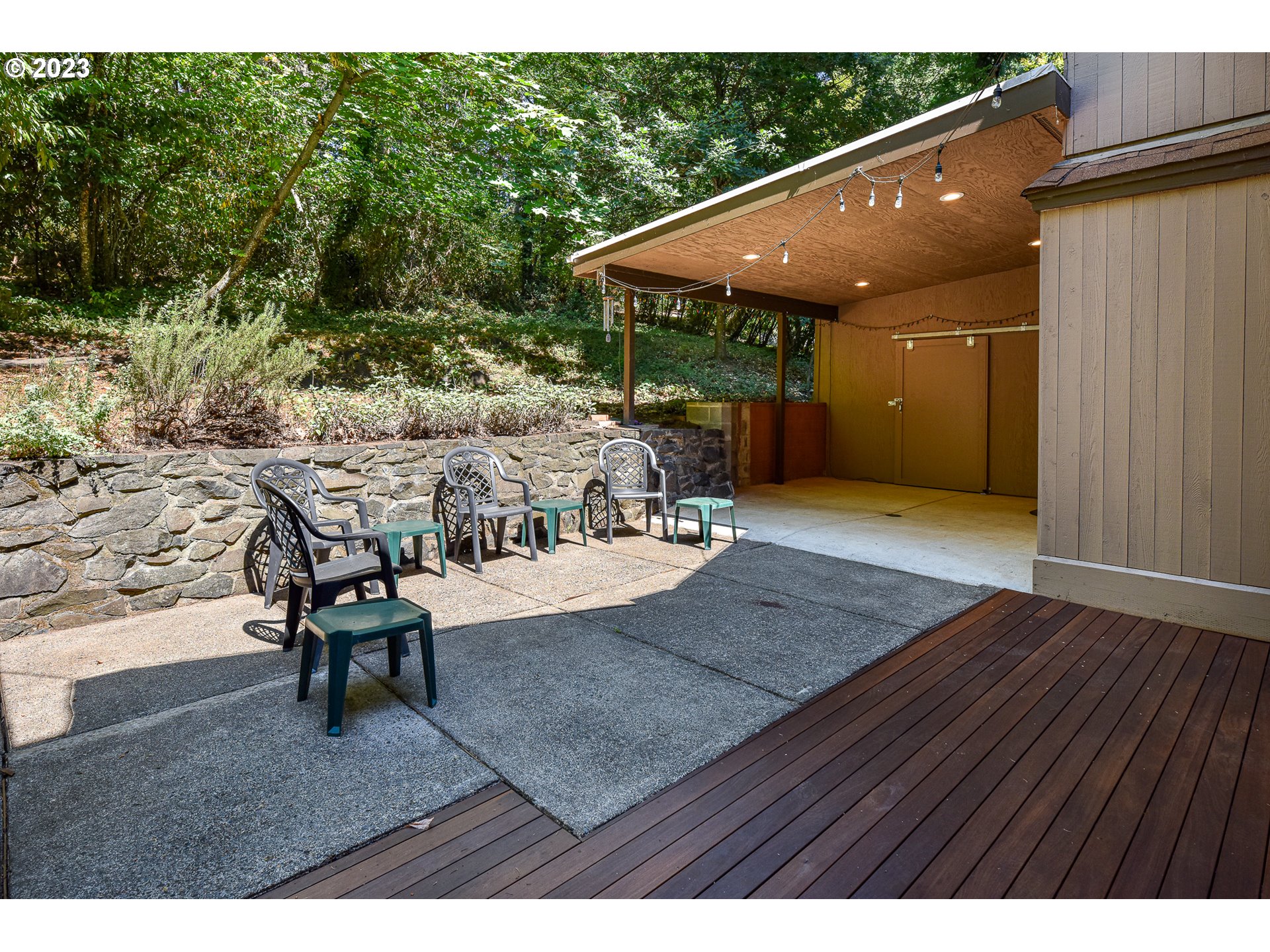 1878 Fircrest Drive Eugene, OR 97403 - Photo 18 of 38 a view of a patio with table and chairs with wooden floor and fence