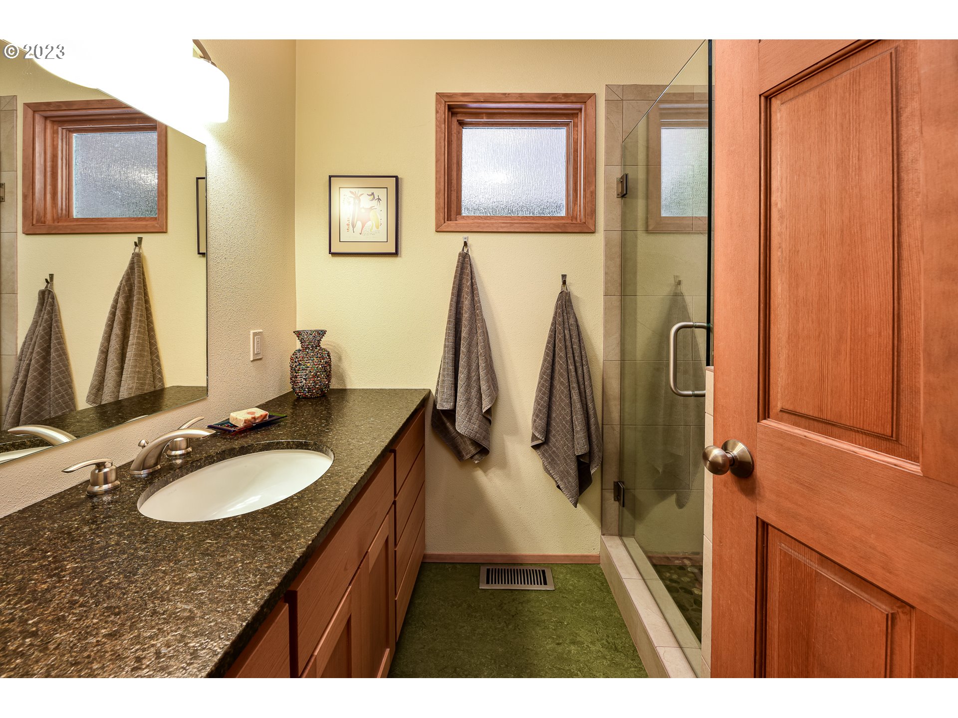 1878 Fircrest Drive Eugene, OR 97403 - Photo 28 of 38 a bathroom with a granite countertop sink and a mirror
