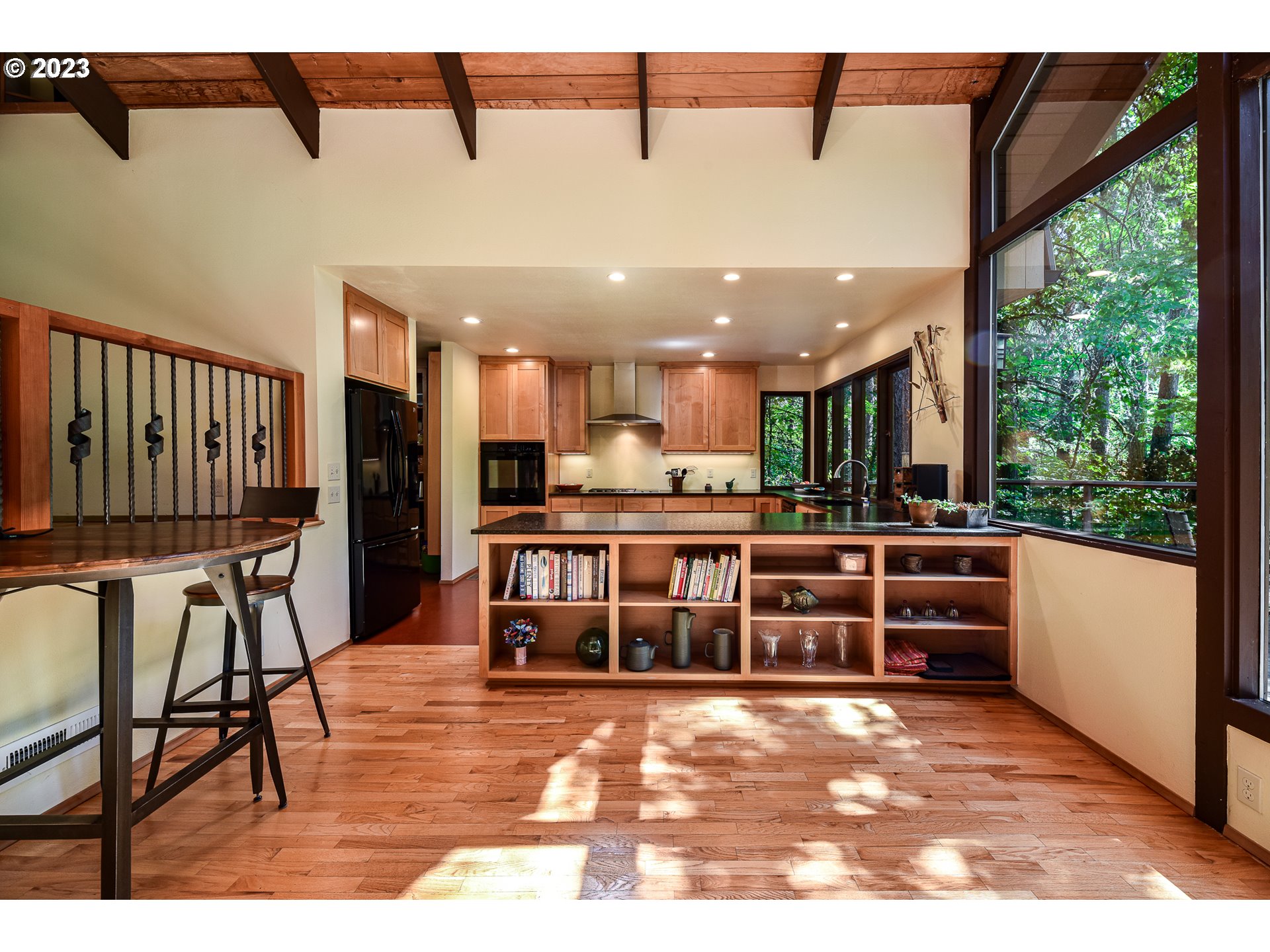 1878 Fircrest Drive Eugene, OR 97403 - Photo 7 of 38 a view of a living room and kitchen with furniture wooden floor and windows