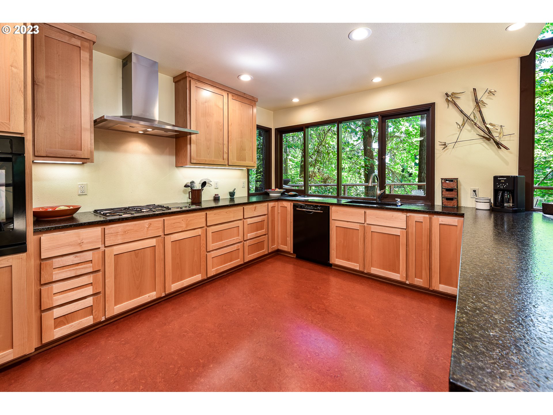 1878 Fircrest Drive Eugene, OR 97403 - Photo 8 of 38 a kitchen with stainless steel appliances granite countertop a stove a sink and a refrigerator with wooden floor