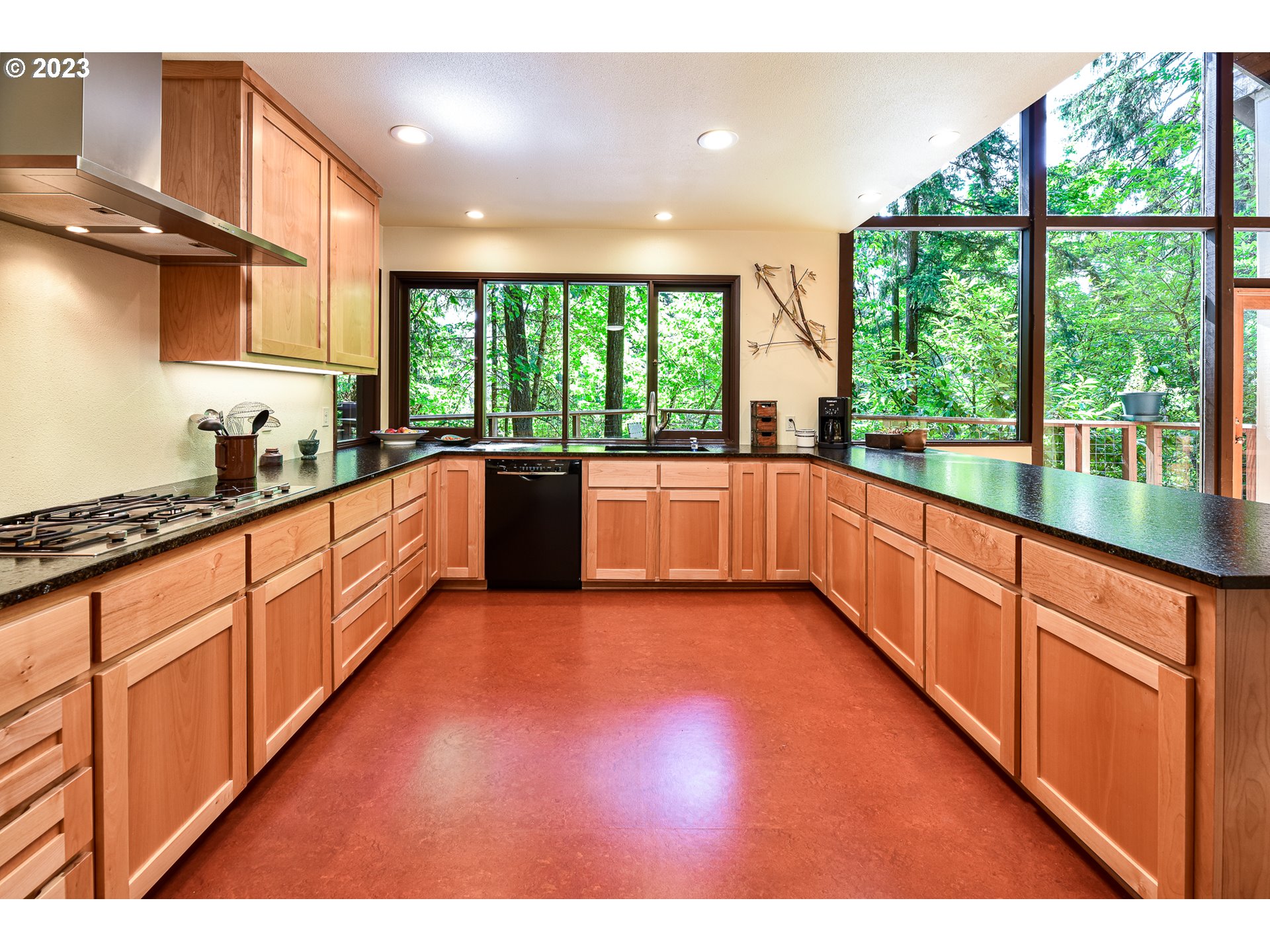 1878 Fircrest Drive Eugene, OR 97403 - Photo 9 of 38 a large kitchen with stainless steel appliances granite countertop a large window a sink and cabinets