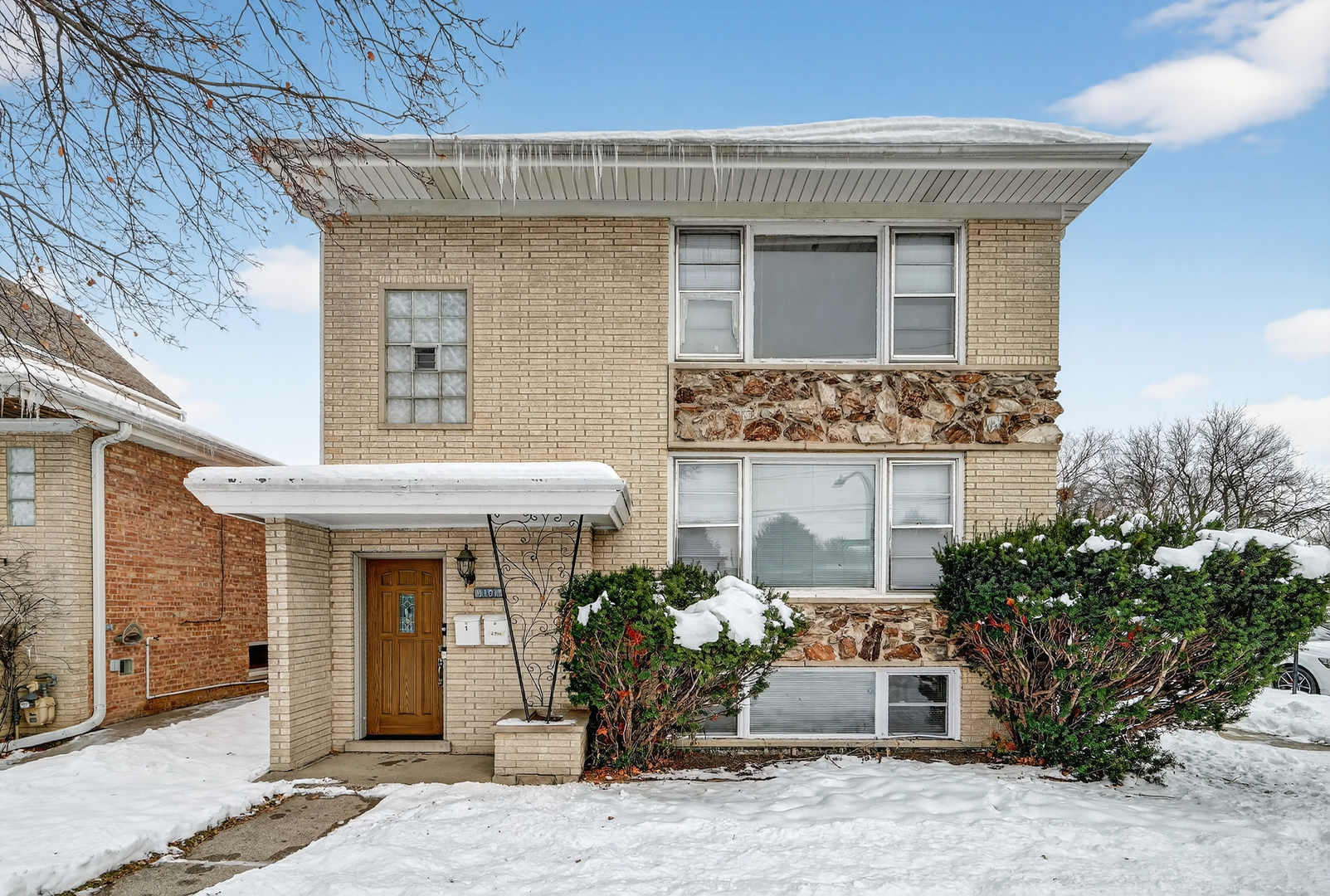 a front view of a house with a garden