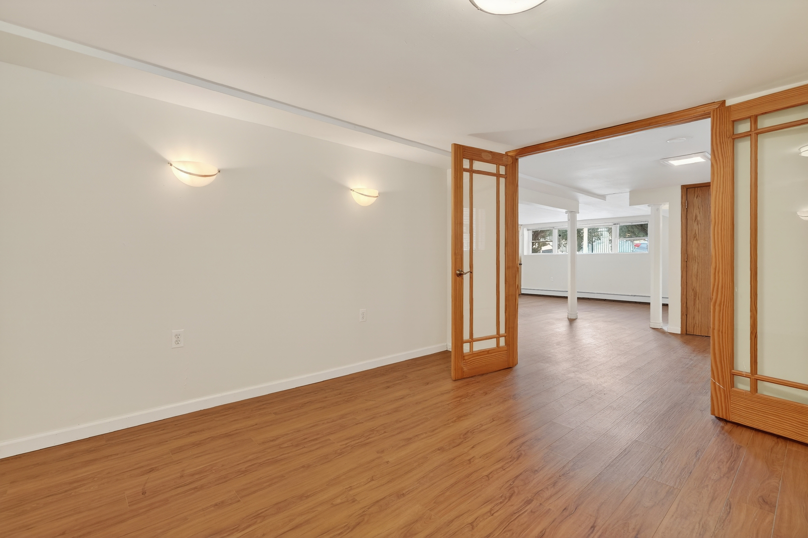5101 North Kenton Avenue, Unit G Chicago, IL 60630 - Photo 14 of 25 a view of a big room with wooden floor and windows