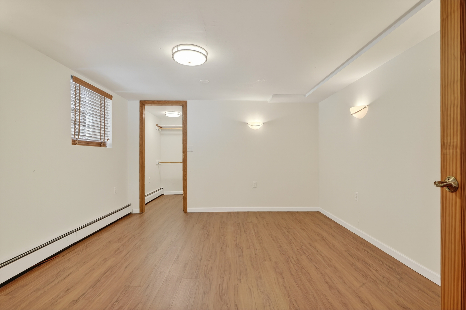 5101 North Kenton Avenue, Unit G Chicago, IL 60630 - Photo 16 of 25 an empty room with wooden floor and windows