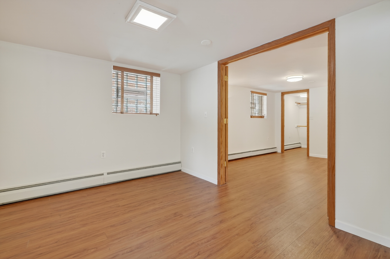 5101 North Kenton Avenue, Unit G Chicago, IL 60630 - Photo 18 of 25 an empty room with wooden floor and windows
