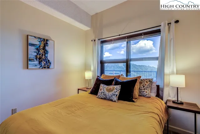 a bed sitting in a bedroom next to a window