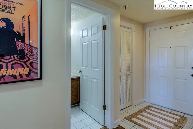 a view of a hallway with wooden floor and closet