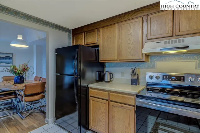 a kitchen with stainless steel appliances granite countertop a refrigerator sink and cabinets