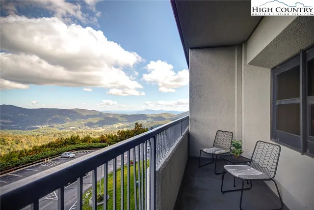 a view of a balcony with chair and a couple of potted plant