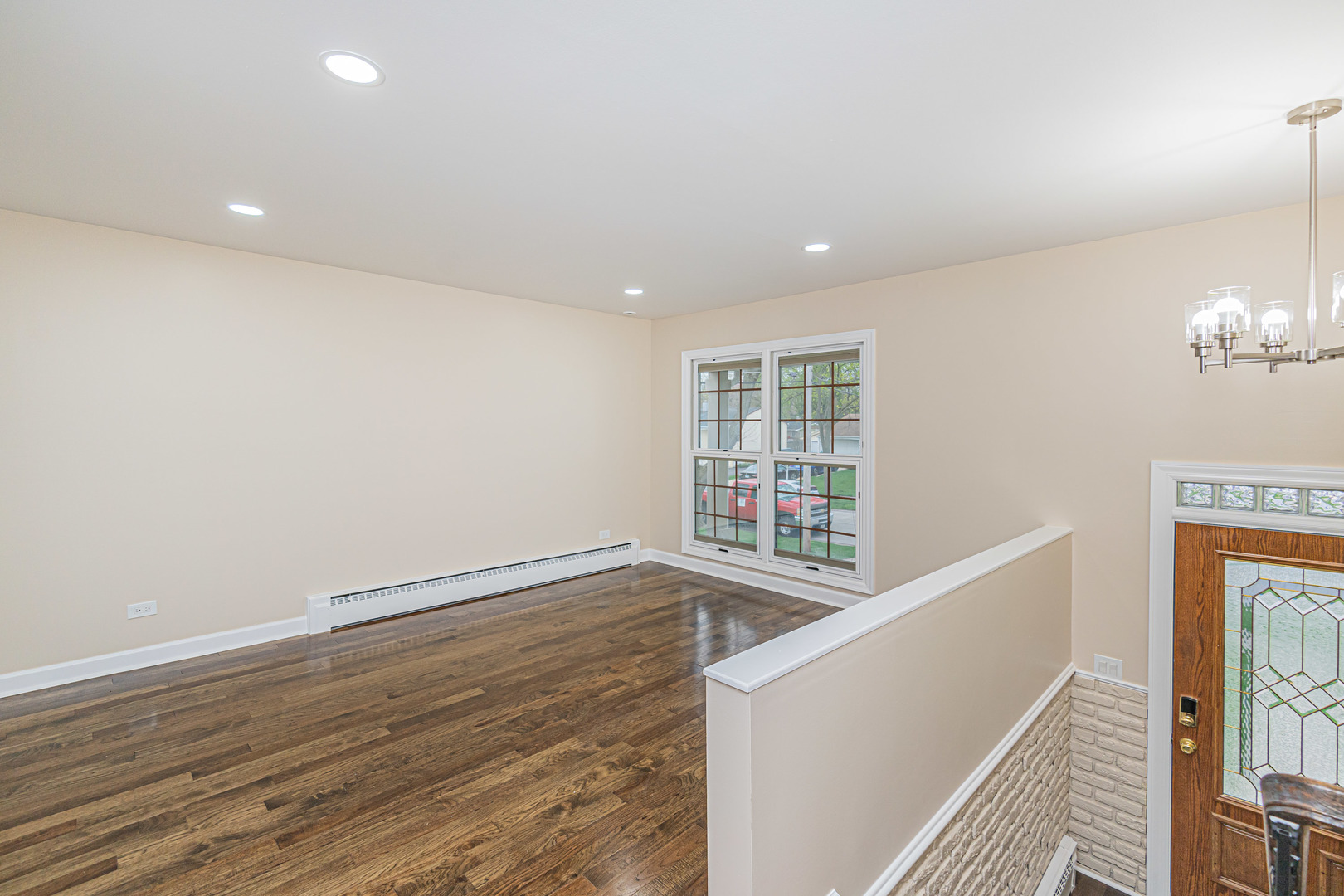 692 Maple Drive Buffalo Grove, IL 60089 - Photo 4 of 30 a view of an empty room with wooden floor and a window