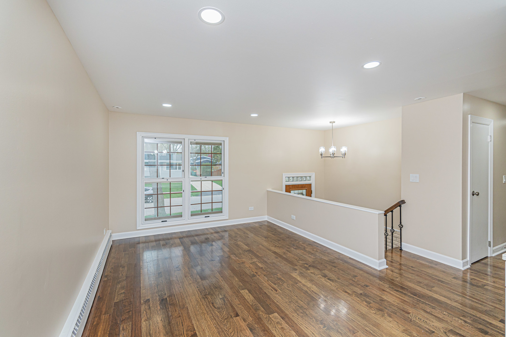 692 Maple Drive Buffalo Grove, IL 60089 - Photo 5 of 30 a view of an empty room with wooden floor and a window