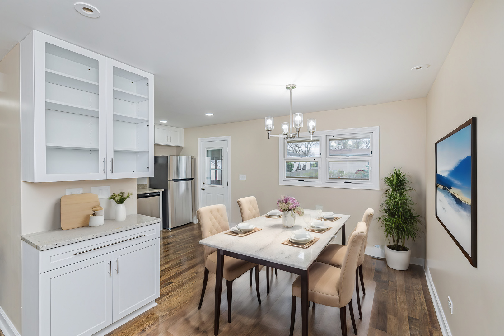 692 Maple Drive Buffalo Grove, IL 60089 - Photo 7 of 30 a kitchen with a table chairs refrigerator and cabinets