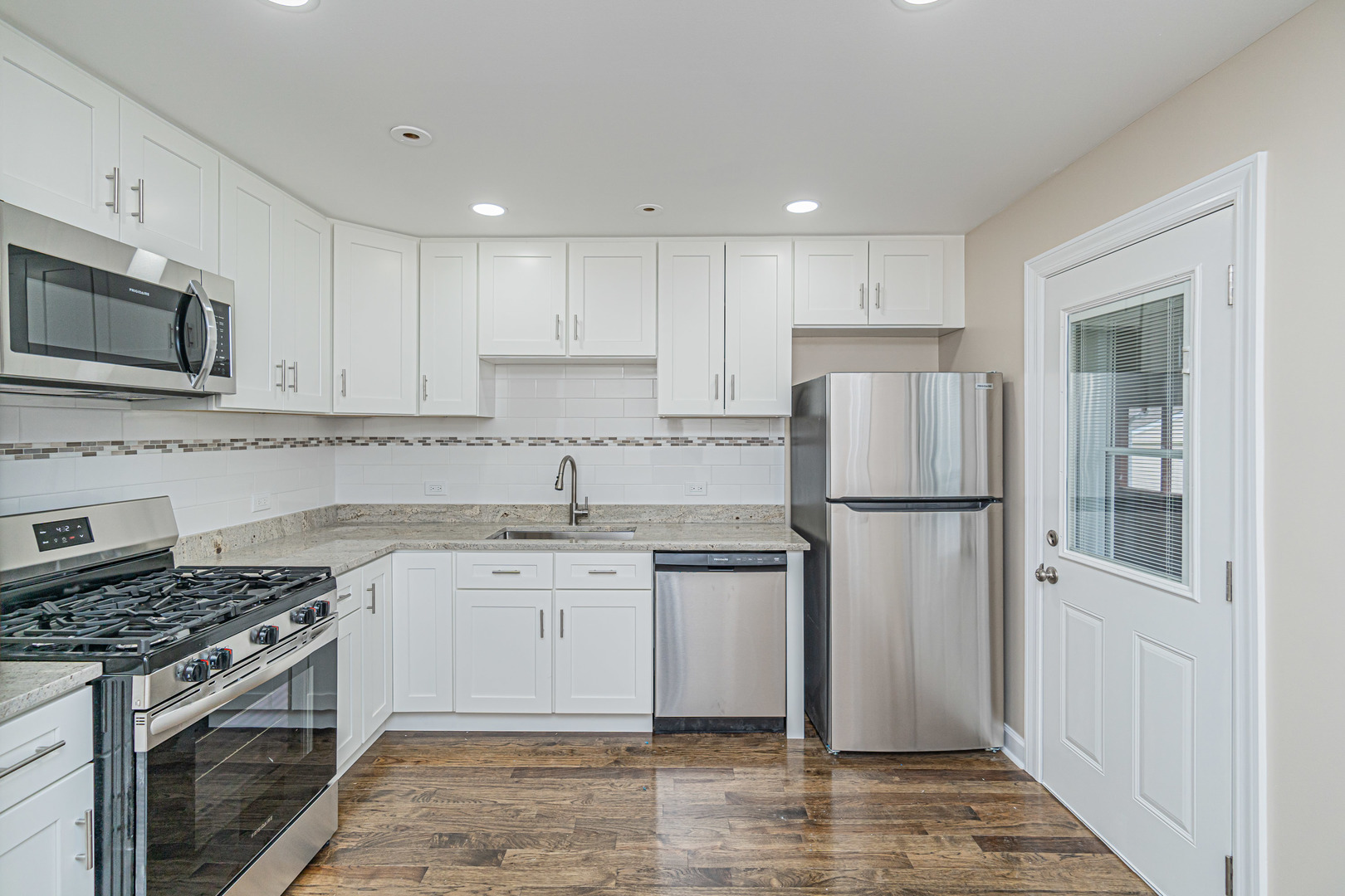 692 Maple Drive Buffalo Grove, IL 60089 - Photo 9 of 30 a kitchen with stainless steel appliances granite countertop a stove a refrigerator and a stove