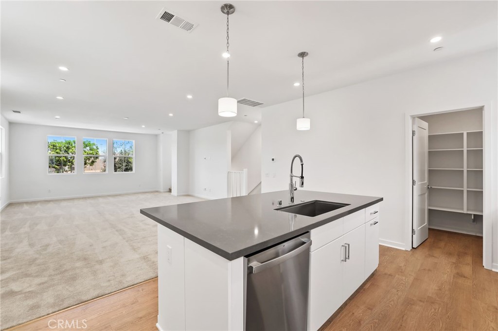 139 Jessup Way Tustin, CA 92780 - Photo 12 of 31 a kitchen with a sink a counter space and wooden floor