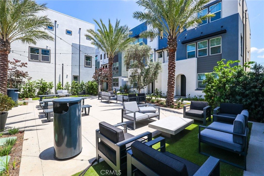139 Jessup Way Tustin, CA 92780 - Photo 5 of 31 a view of a patio with couches table and chairs potted plants and palm tree