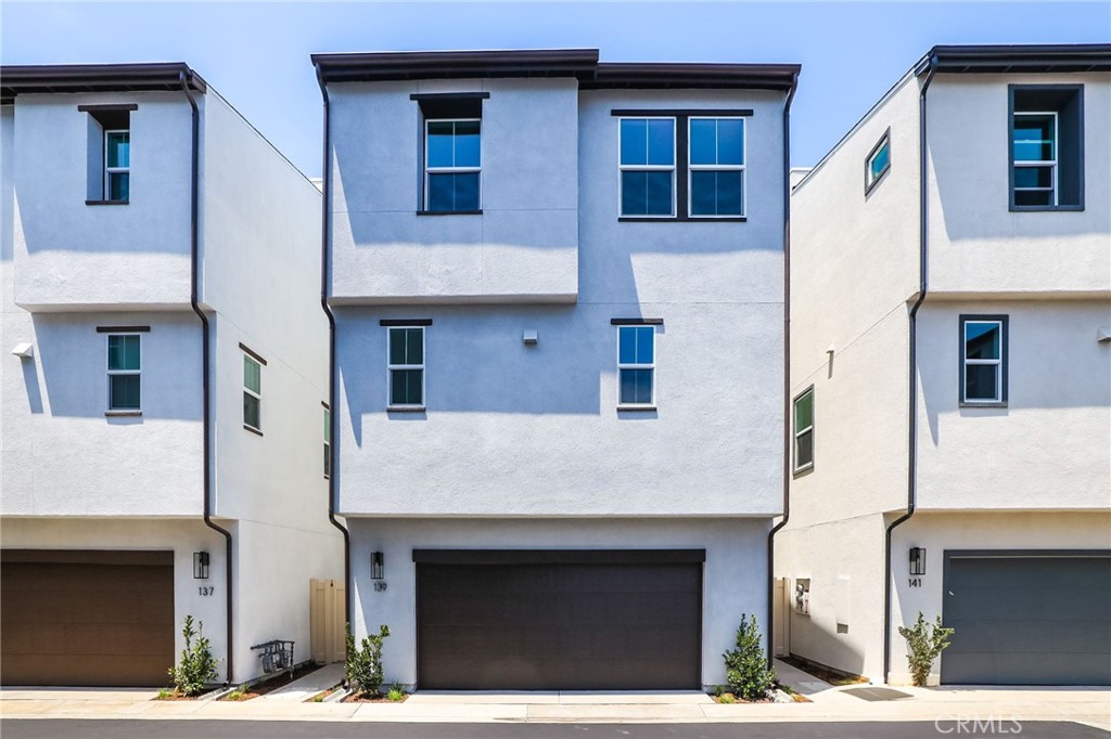 139 Jessup Way Tustin, CA 92780 - Photo 8 of 31 a front view of a house with large windows