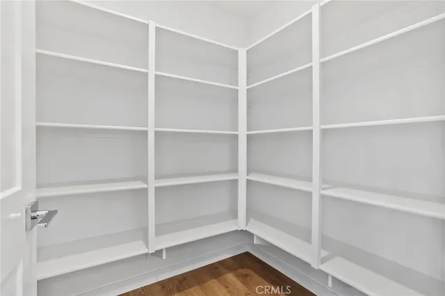 a kitchen with kitchen island granite countertop a sink a counter space appliances and cabinets