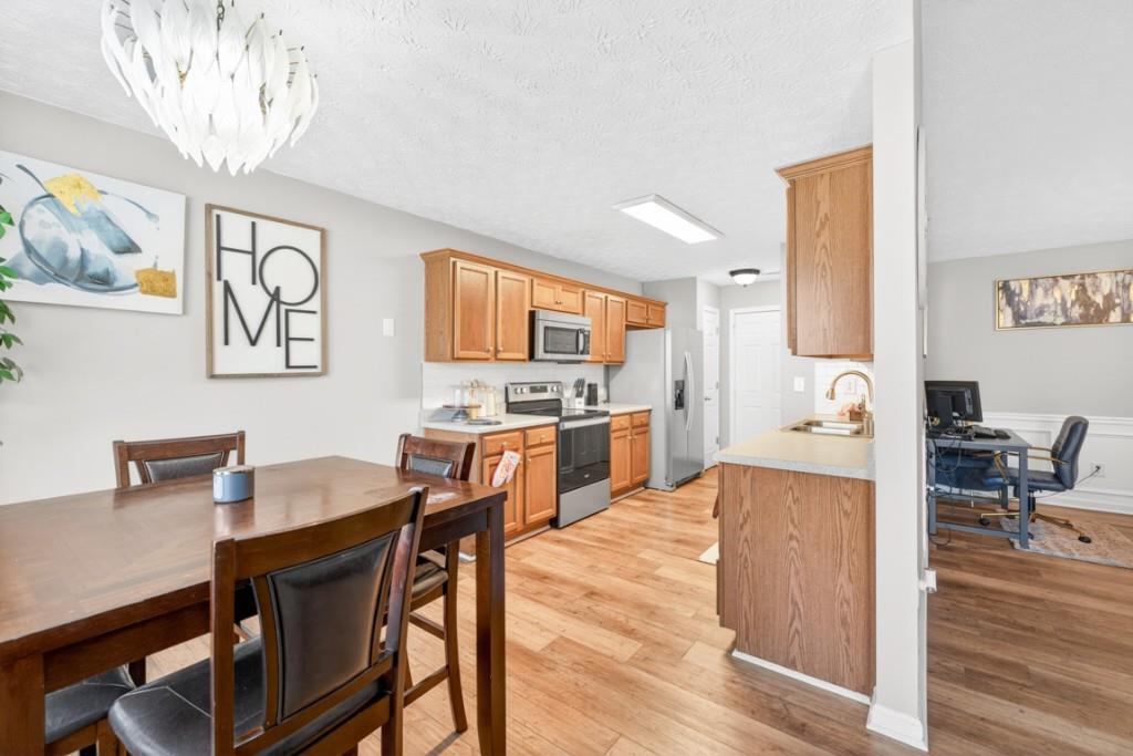 1501 Cardinal Lane Winder, GA 30680 - Photo 11 of 33 a view of a dining room with furniture a chandelier and wooden floor