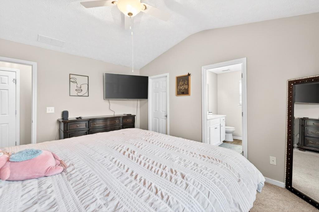1501 Cardinal Lane Winder, GA 30680 - Photo 18 of 33 a bedroom with a bed and a flat tv screen on dresser
