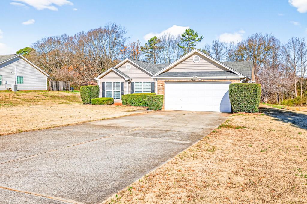 1501 Cardinal Lane Winder, GA 30680 - Photo 3 of 33 a view of a house with a yard and large trees