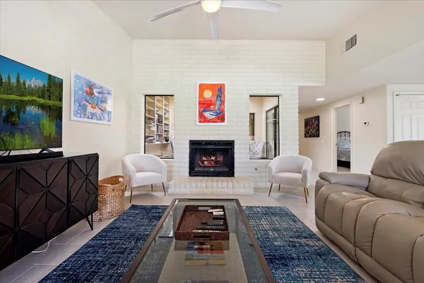a living room with furniture a rug and a fireplace