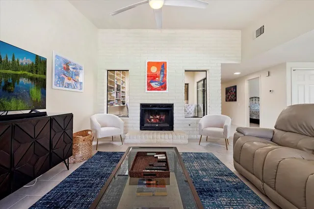 a living room with furniture a rug and a fireplace