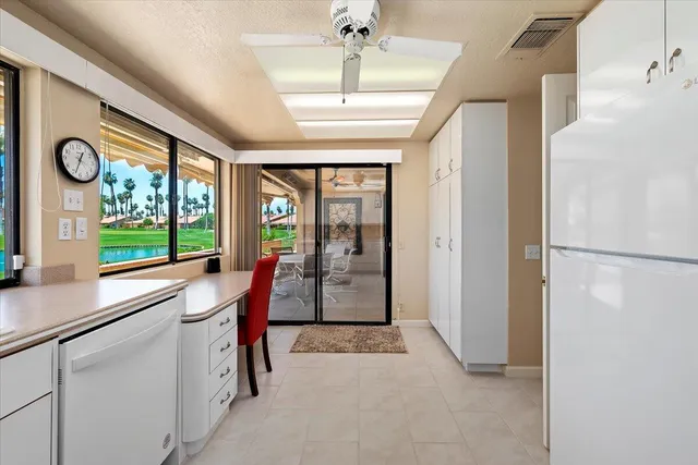 a view of a hallway with furniture and a window